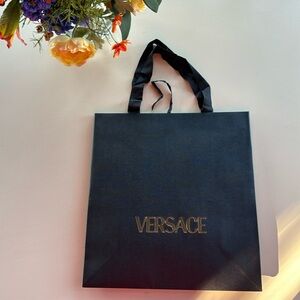 Versace black shopping bag with tissue paper.